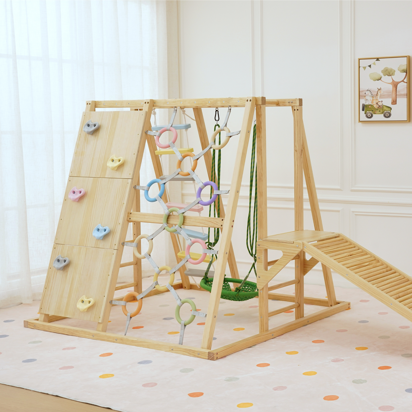 Front view of Sweetgum indoor play gym showing climbing wall, swing, rope net, and pastel rings