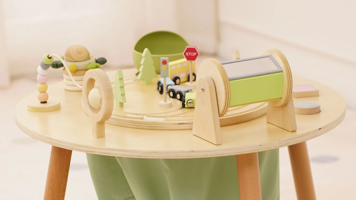 Toddler using the wooden activities on the Avenlur Aldar convertible Montessori activity table