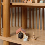 Wooden toys on a wooden shelf with a blurred background