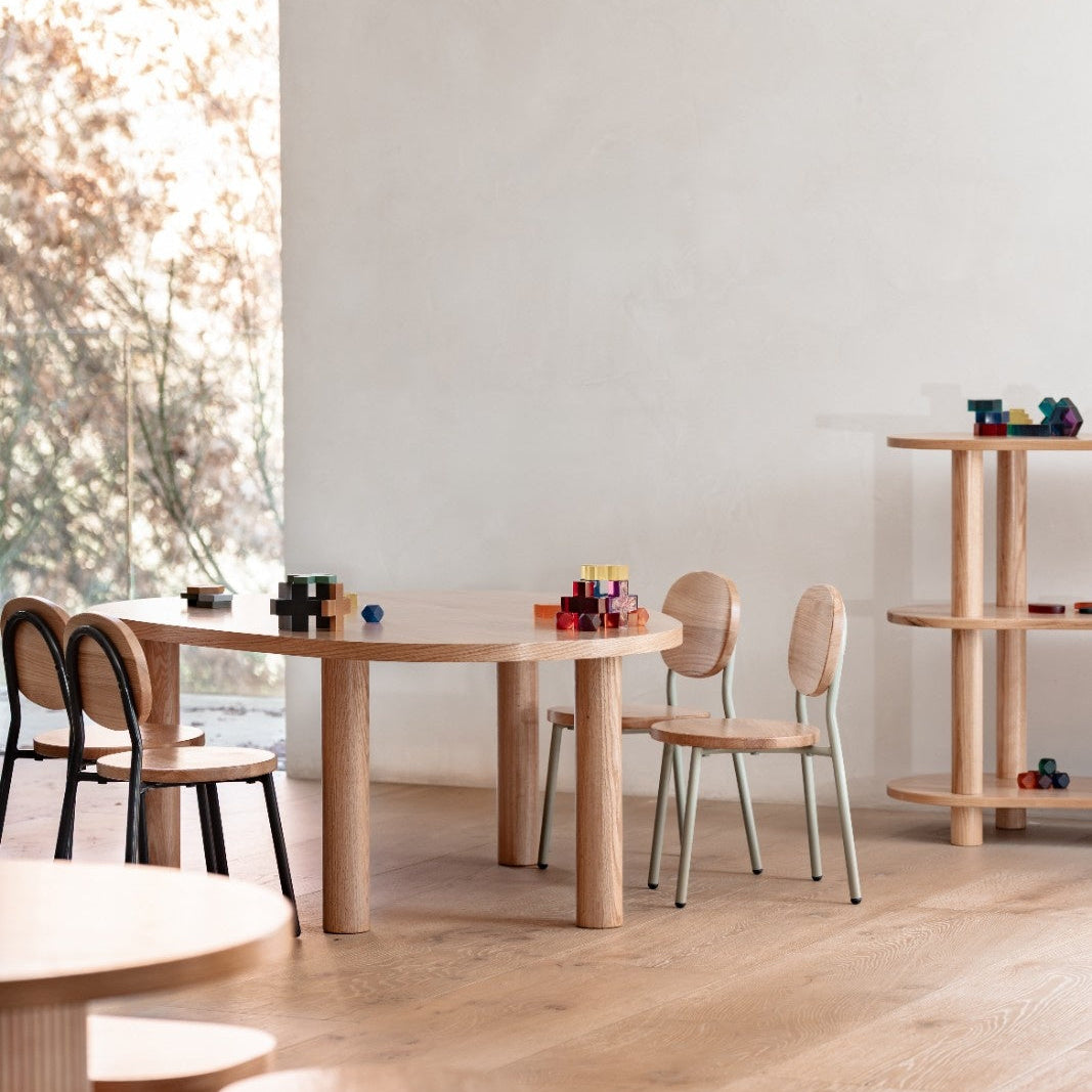 Modern wooden furniture set in a minimalistic room with light-colored walls and floor.