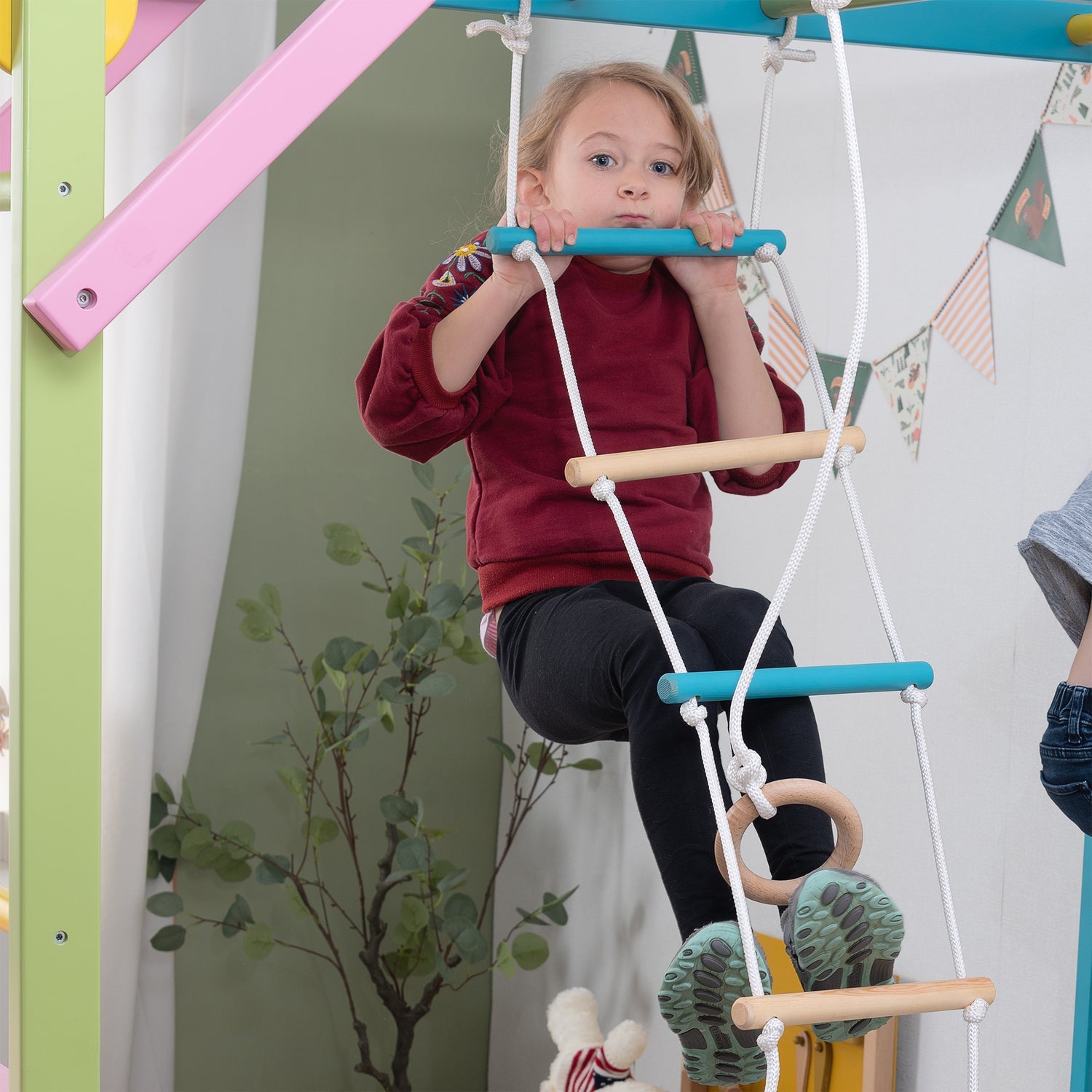 Girl on Rope Ladder of The Grove Jungle Gym - Avenlur's Premium 8 in 1 Wooden Playset for Older Kids - Colorful Edition