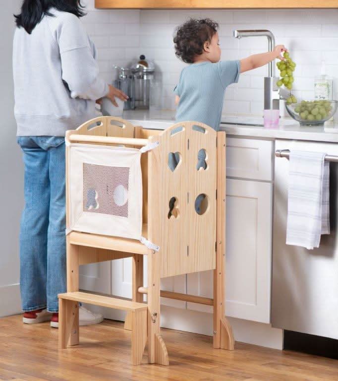 Avenlur Plum foldable kitchen tower used as a toddler step stool