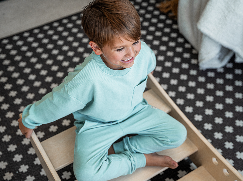 Child Smiling in Rowan - Avenlur's Reversible Rocking Boat & Bridge
