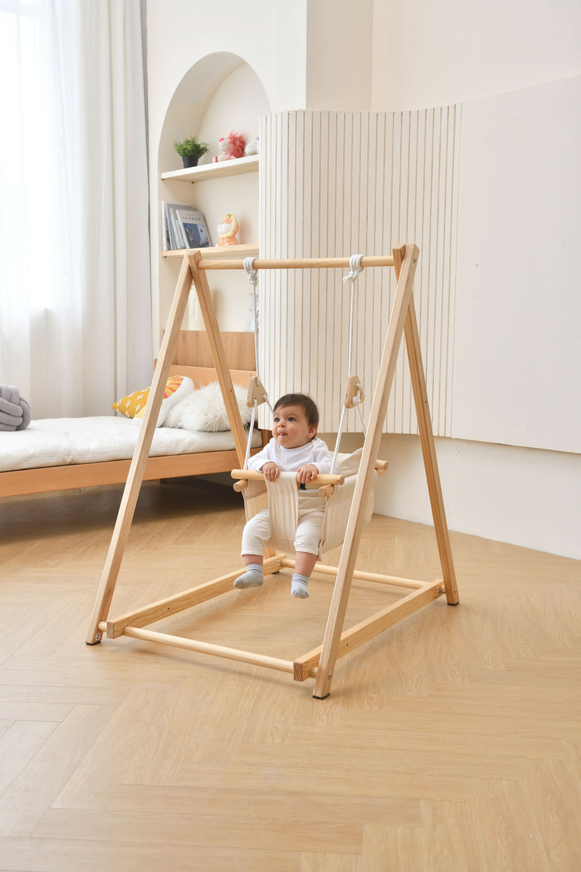 Baby in the Avenlur Spruce wooden indoor swing with stand