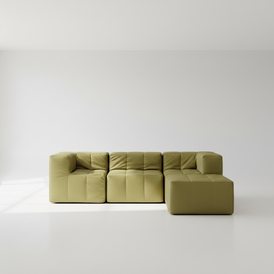 Green sectional sofa on a white floor with a white wall background