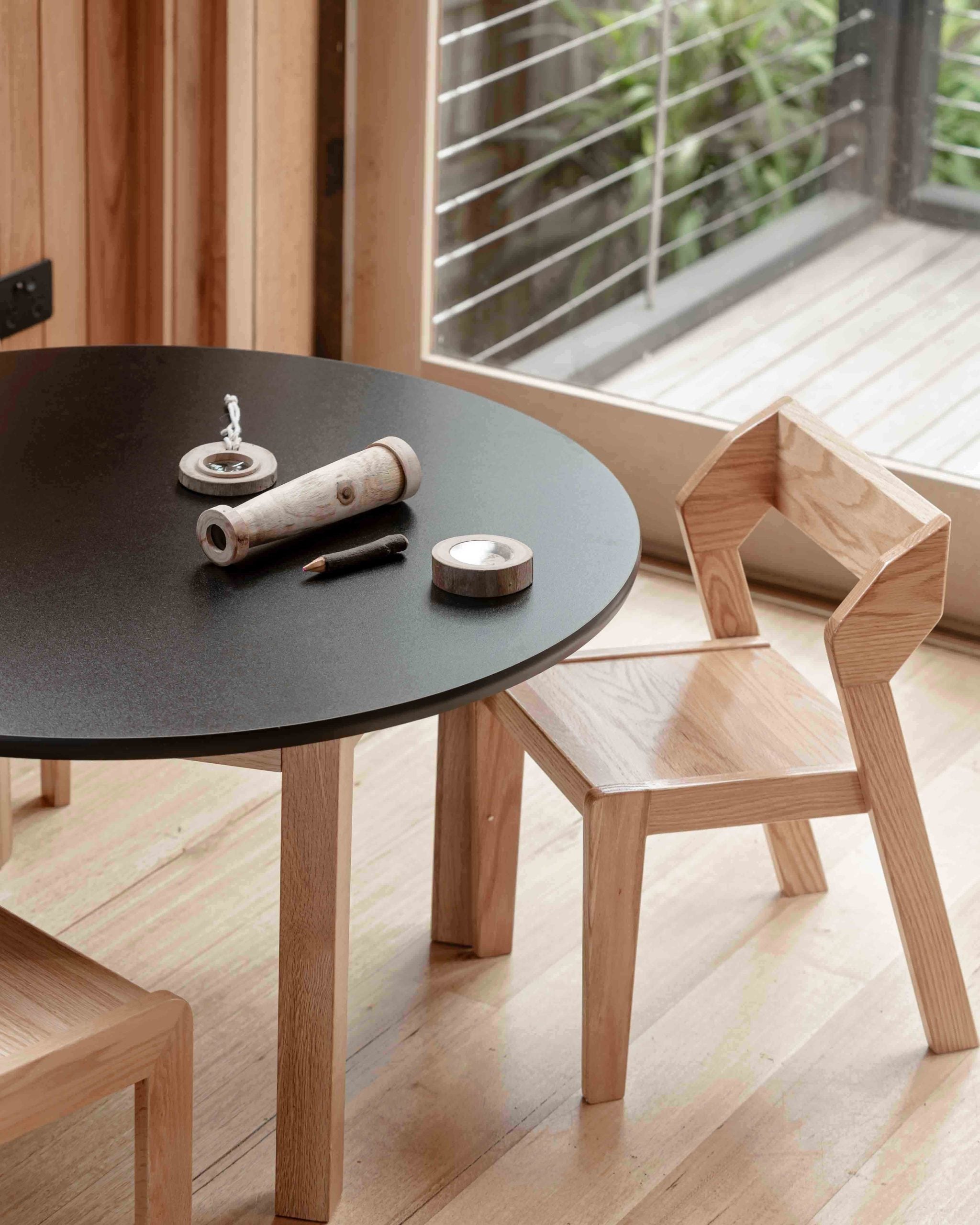 Close-up of Alfie stacking chair showing geometric backrest and contoured seat