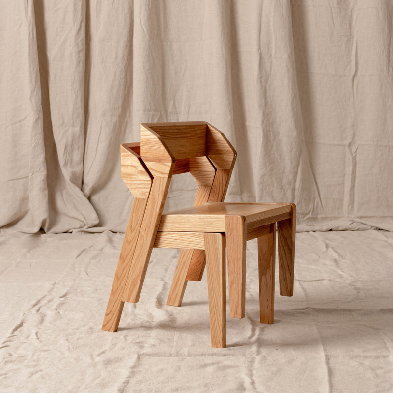 Two Alfie chairs stacked together, showing efficient storage