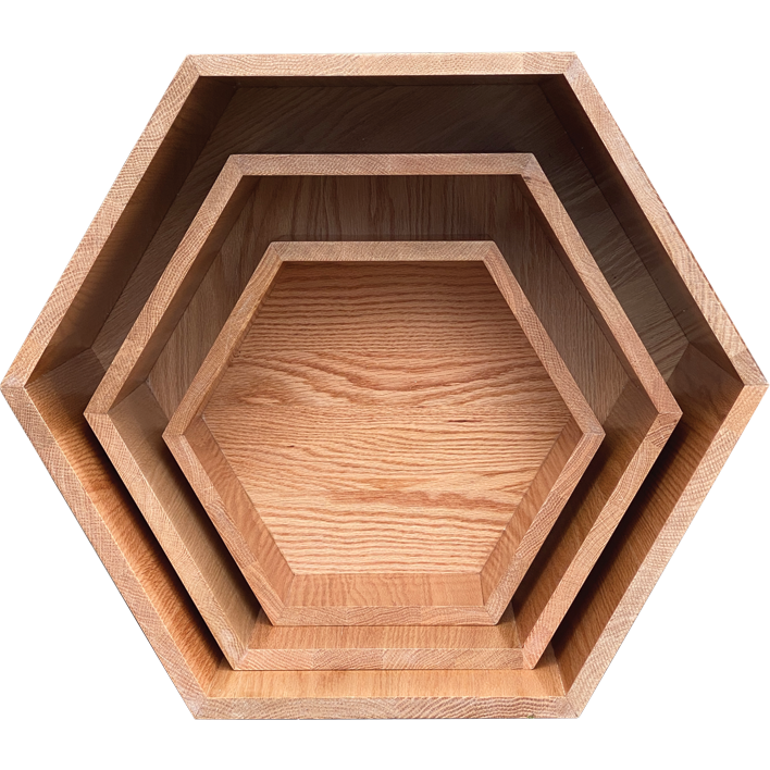 Set of three wooden hexagonal trays on a white background