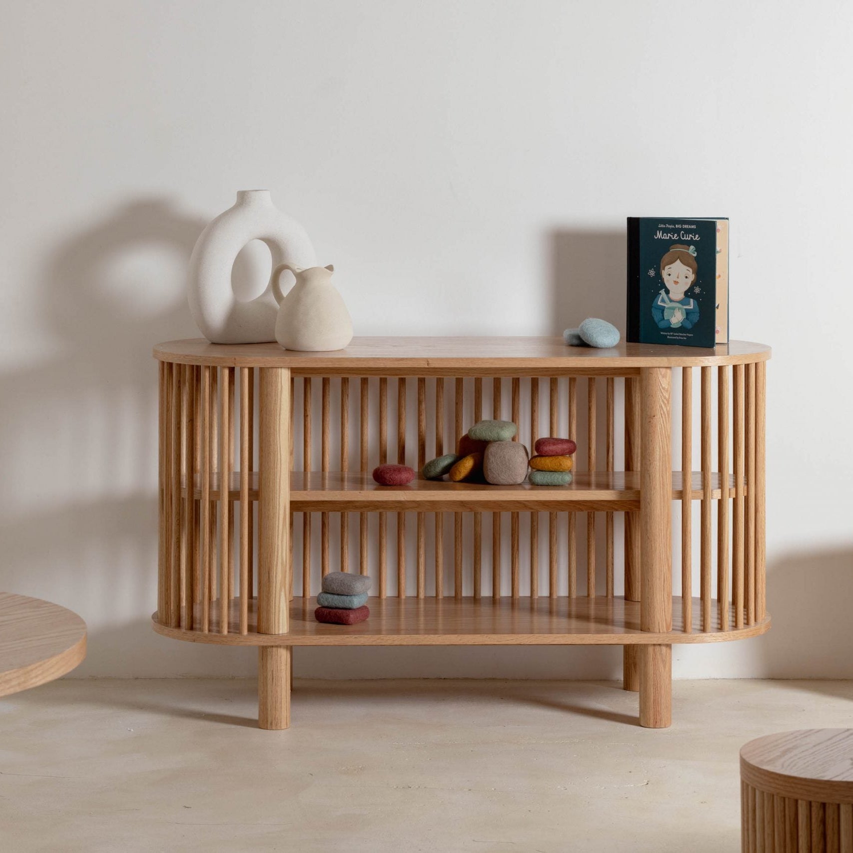 Wooden shelf with decorative items against a plain wall