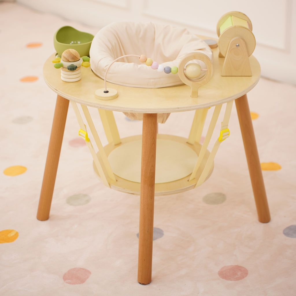Baby standing at the Avenlur Aldar baby activity table