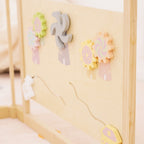 Baby playing with the xylophone and spinner activity panel on the Avenlur playpen
