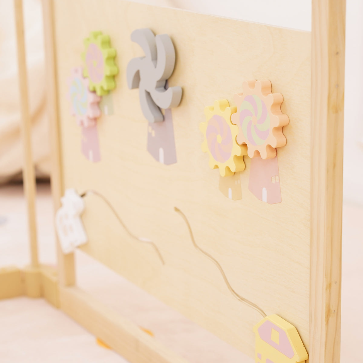 Baby playing with the xylophone and spinner activity panel on the Avenlur playpen