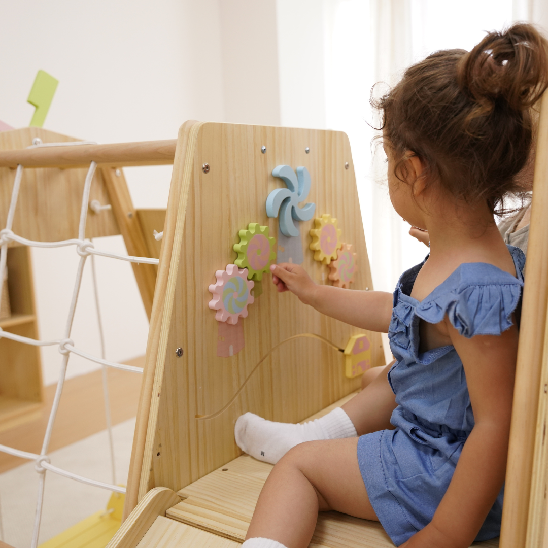 Toddler climbing the Avenlur Cherry indoor climber for toddlers
