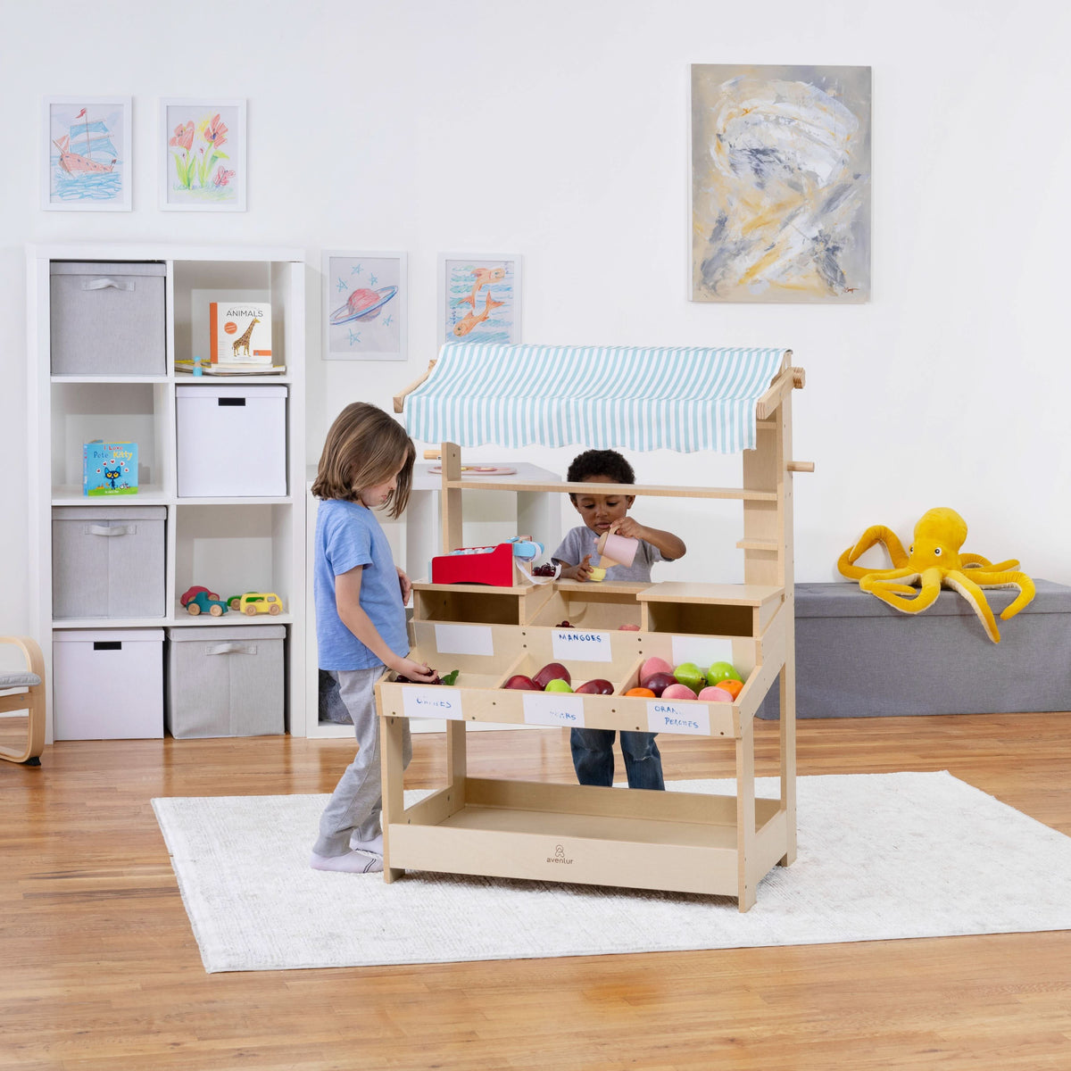 Kids playing shopkeeper at the Avenlur Cypress market stand