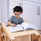 Child using the Avenlur Date kitchen helper tower to wash vegetables