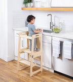 Toddler standing in the Avenlur Date kitchen tower at the counter