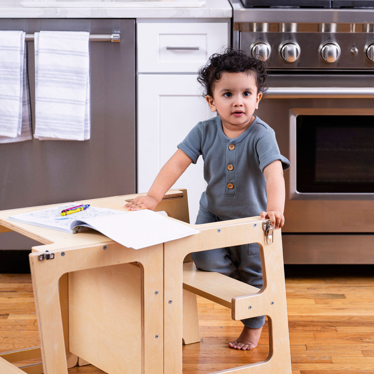 Toddler helping cook from the Avenlur Date toddler tower