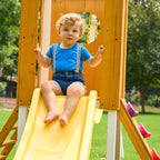 Toddler climbing into the Avenlur Forest Small playhouse