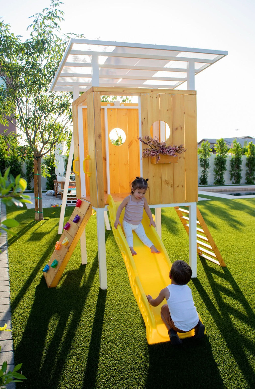 Child climbing the Avenlur Forest swing set