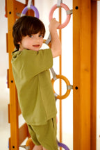 Kid swinging on the Avenlur Hawthorn outdoor playset