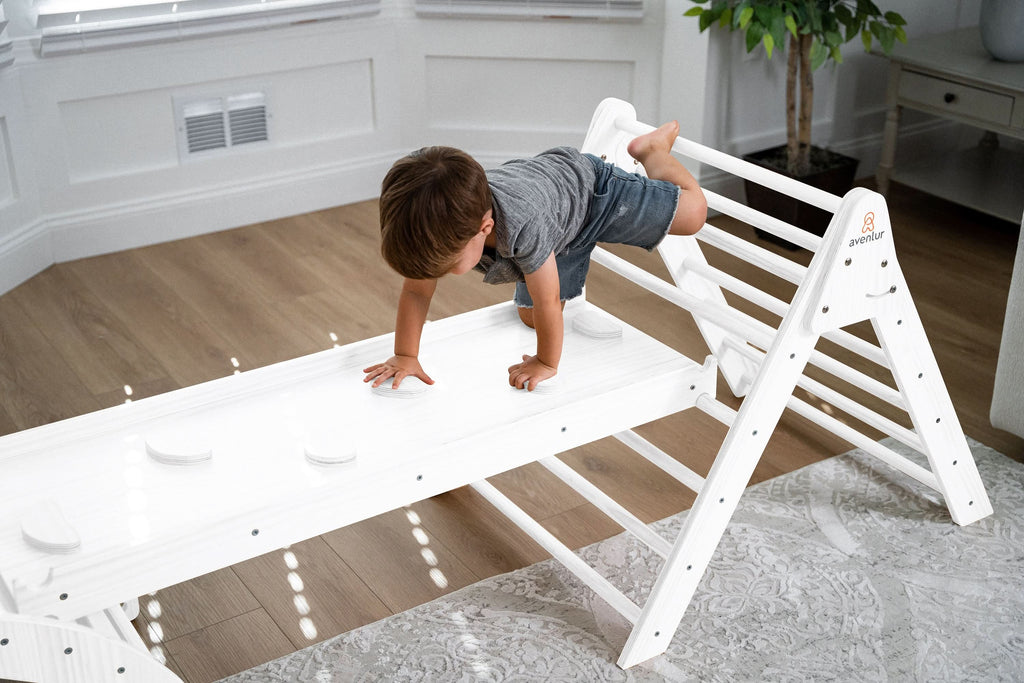 Two kids sharing the Avenlur Hazel wooden rocker