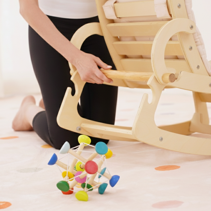 Baby relaxing awake in the Avenlur Hemlock rocker in the living room
