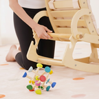 Baby relaxing awake in the Avenlur Hemlock rocker in the living room
