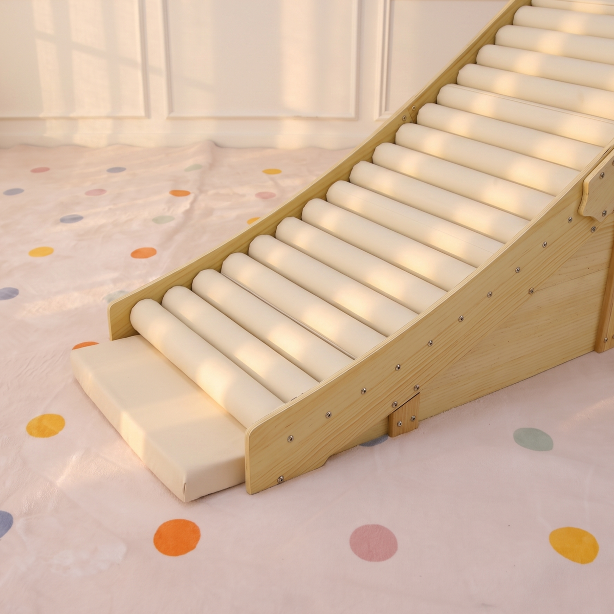 Toddler rolling down the Avenlur Hickory soft foam slide