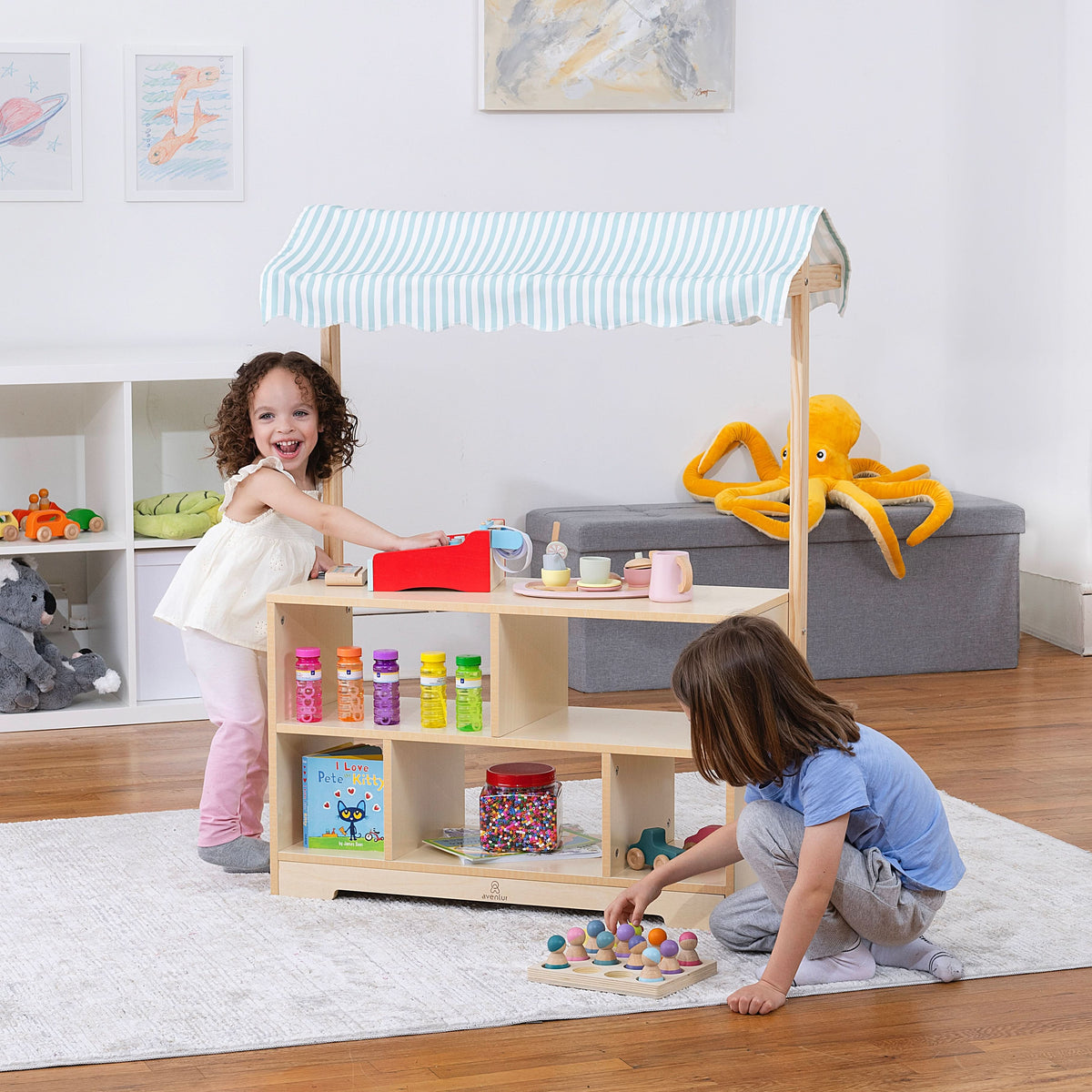 Avenlur Holly market stand doubling as a Montessori bookshelf