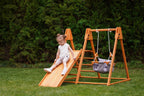 Toddler on the Avenlur Juniper outdoor climbing toy in the yard