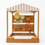Avenlur Koa water wall and gear panel with striped market canopy