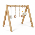 Baby reaching for toys on the Avenlur Lilac Montessori play gym