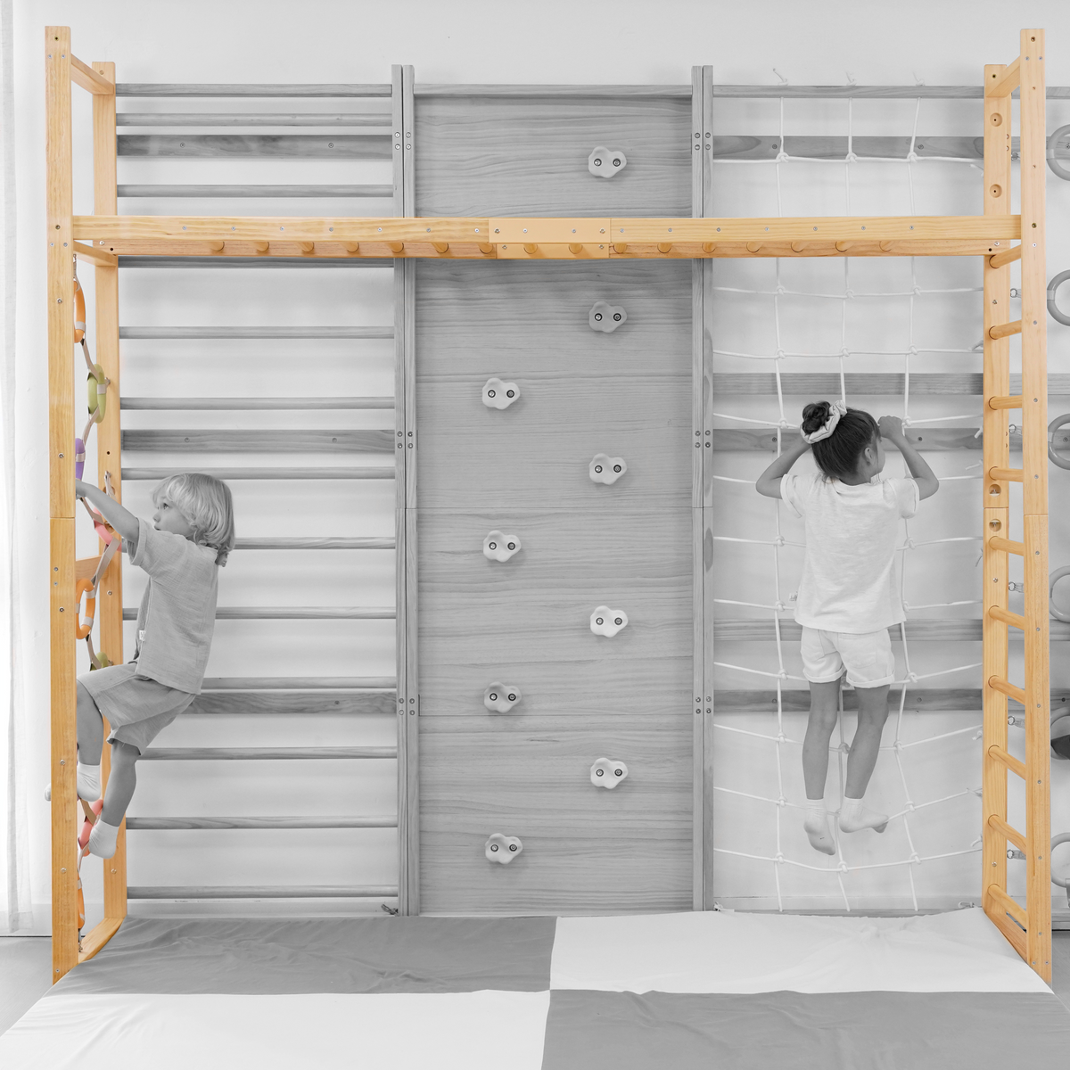 Avenlur monkey bars for kids attached to a Swedish ladder, gray mat
