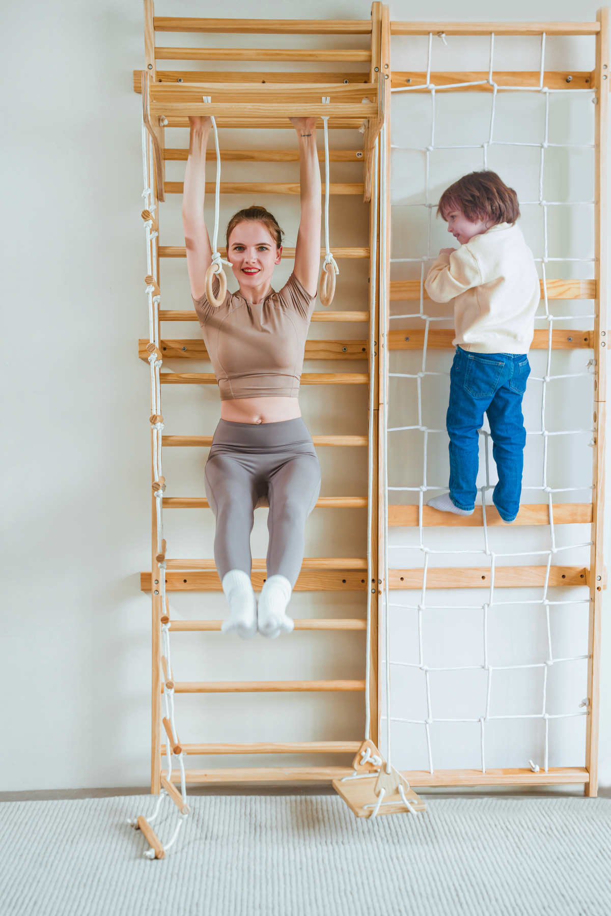 Avenlur Neem rope climbing wall for kids next to a wooden wall ladder