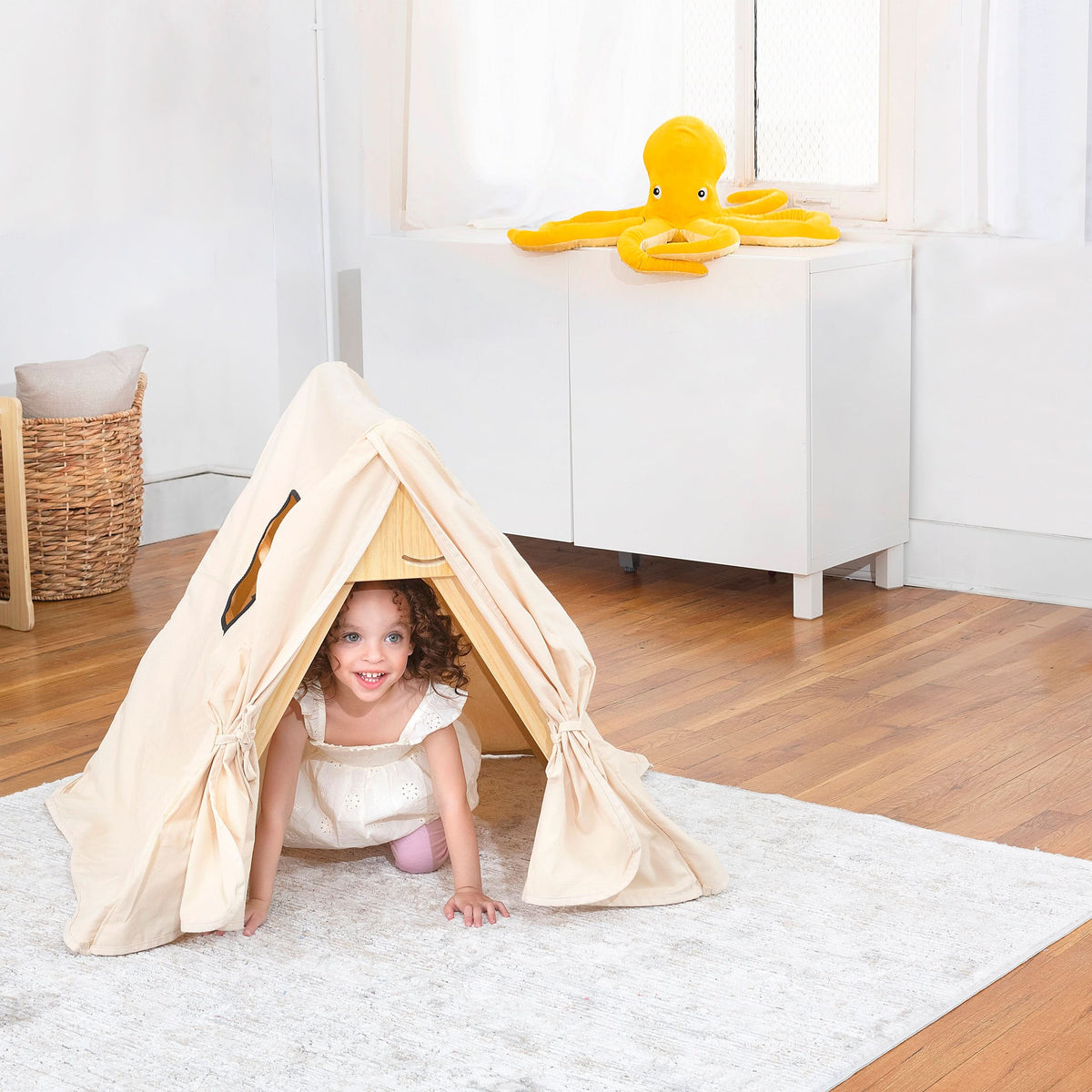 Child reading inside the Avenlur Pikler triangle tent