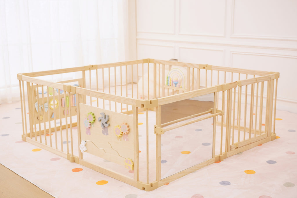 Baby pulling up on the Avenlur playpen safety mirror bar