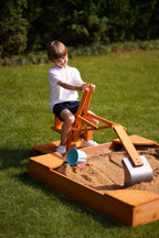 Child digging in a sandbox with the Avenlur ride-on excavator