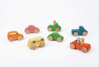 Toddler playing with Avenlur wooden toy cars on the floor