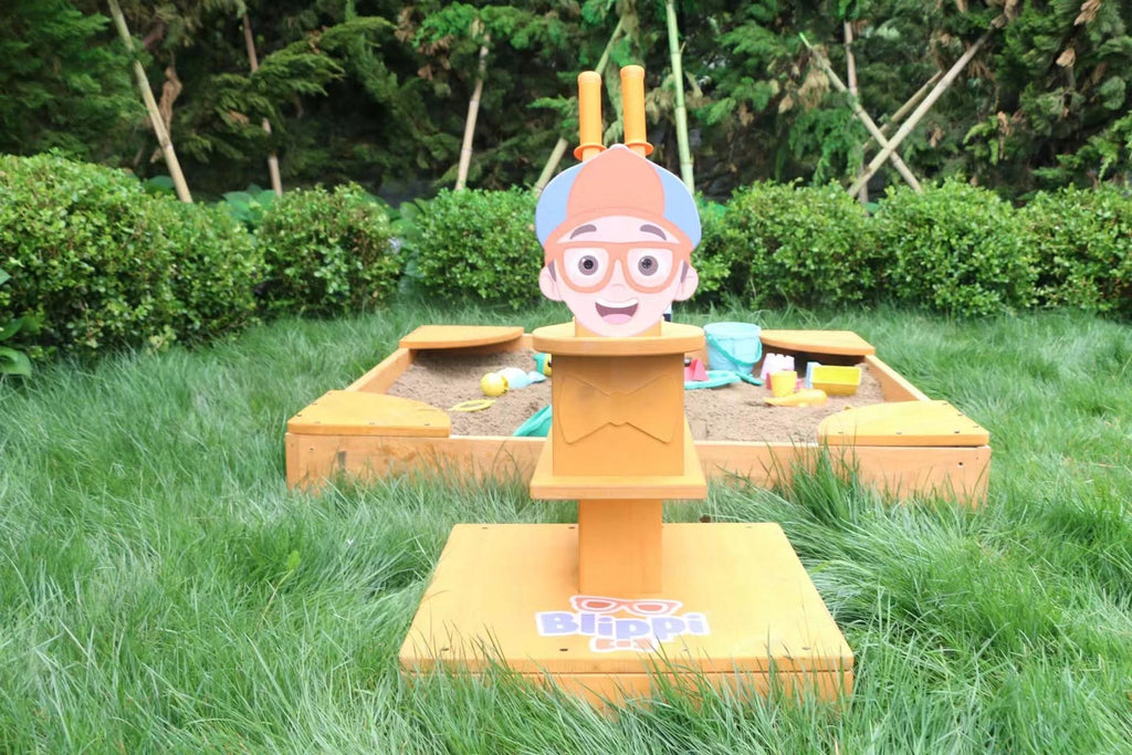 Child digging sand with the Blippi excavator