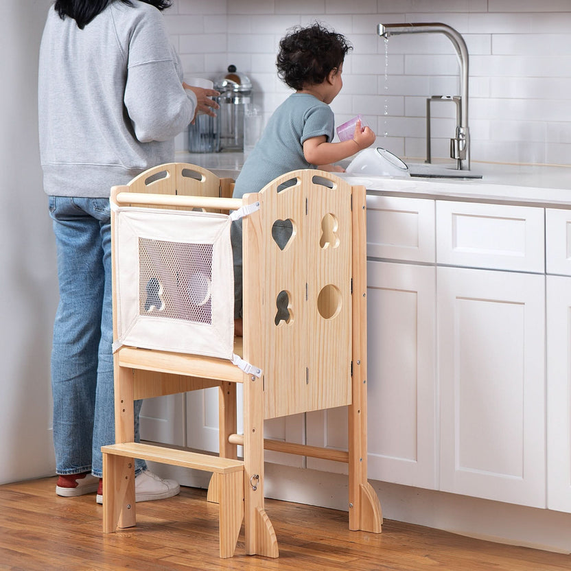 Toddler standing at the kitchen counter in an Avenlur wooden kitchen tower