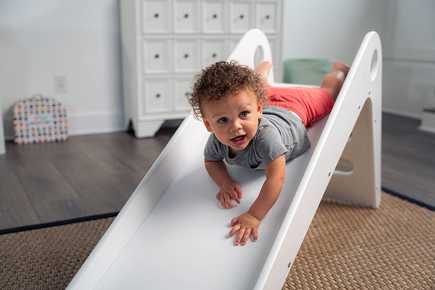 Toddler Sliding Down Manuka - Avenlur's Safe and Fun Indoor Toddler Slide in Playroom. Shown in White.