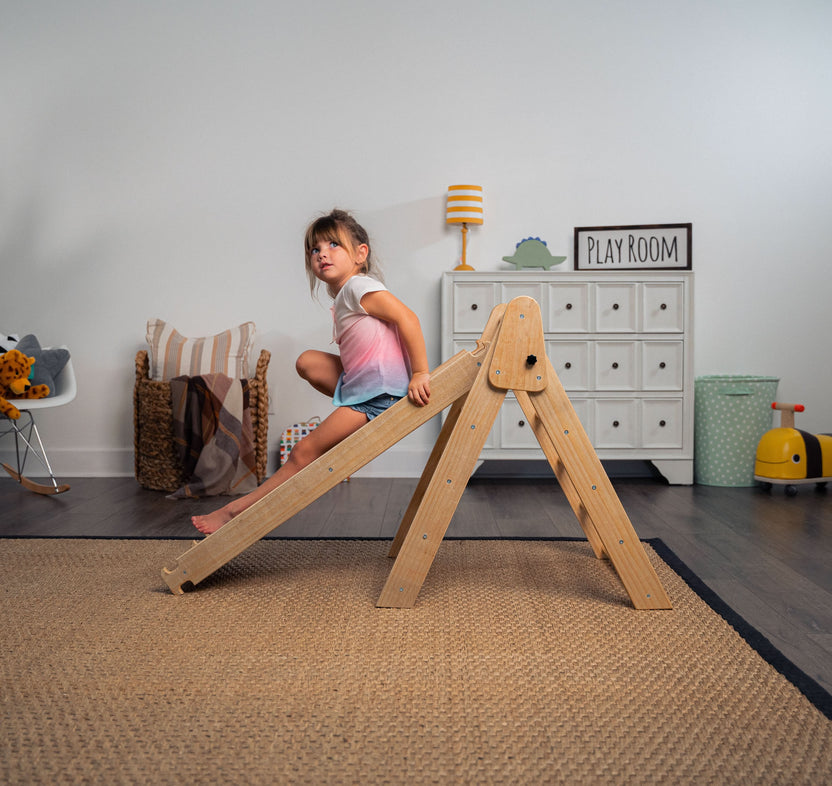 Toddler climbing an Avenlur wooden Pikler triangle