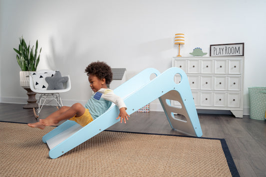 Child Sliding Down Manuka - Avenlur's Safe and Fun Indoor Toddler Slide in Playroom. Shown in Blue