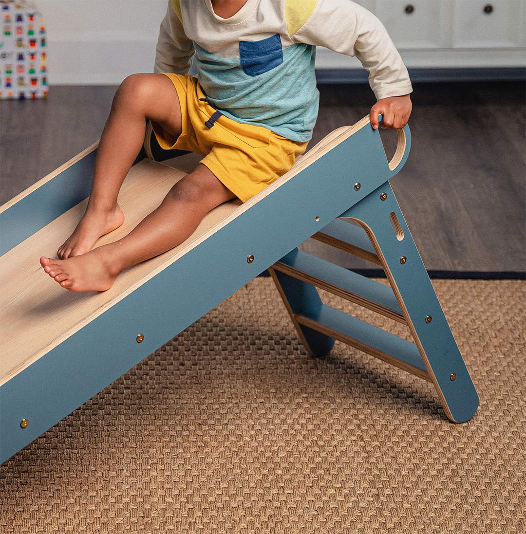 Close Up of Child Sitting on Avenlur's Holland Folding Slide in Blue