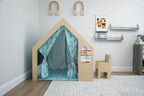 Child drawing at the desk inside the Avenlur Flair wooden playhouse