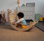 Child sitting inside Avenlur Hazel Pikler Rocking Arch in cozy playroom setting