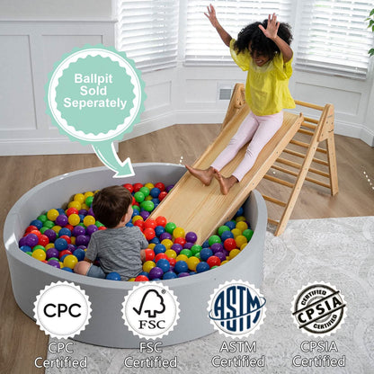Child sliding from Avenlur Hazel Pikler Triangle into ball pit with CPC, FSC, ASTM, and CPSIA certifications shown – ball pit sold separately