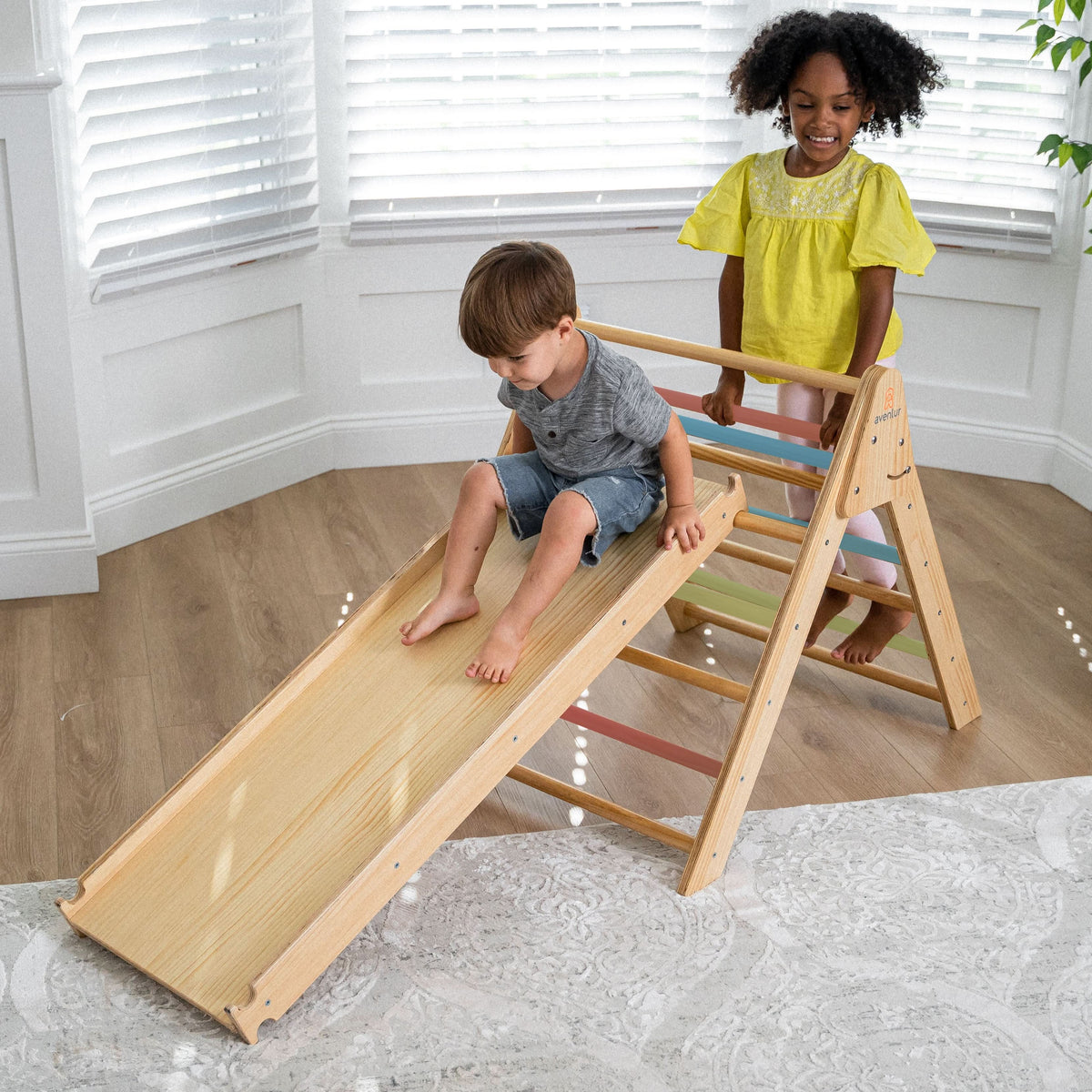 Toddler rocking in the Avenlur Hazel rocking arch