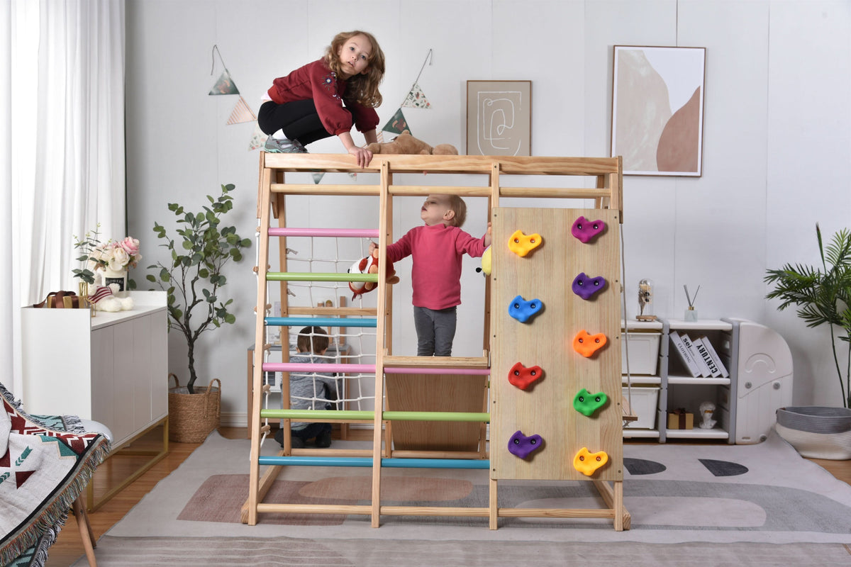 Kids playing on the Avenlur Magnolia wooden jungle gym in a home playroom