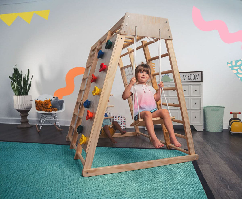 Avenlur Magnolia indoor wooden jungle gym in rainbow color finish with monkey bars, rock wall and slide